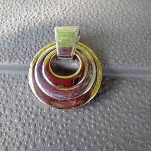 Women's reversible two tone pendant.